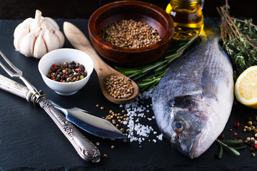 Fresh fish dorado with fragrant spices, herbs and spices