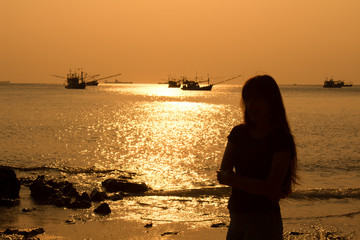 Young woman on beach in evening sunlight