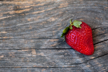 A cut strawberry on a wooden background