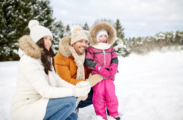 Fototapeta na wymiar happy family with child in winter clothes outdoors