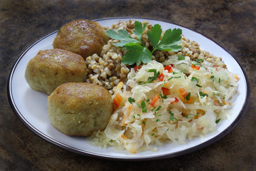 Chicken cutlets with buckwheat and salad  with sauerkraut, carrots and paprika