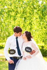 Funny bride and groom with Mr and Mrs signs. Happy wedding day