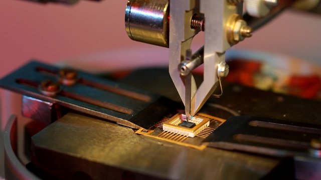 Universal wire bonder microelectronic equipment in work close-up