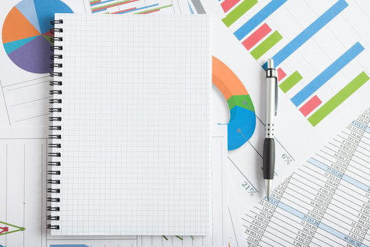 Empty notebook and business documents on a desk