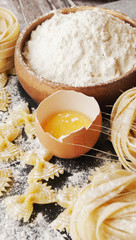 Uncooked pasta with flour on the table, selective focus