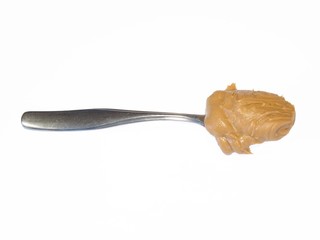 Spoonful of peanut butter on white background,