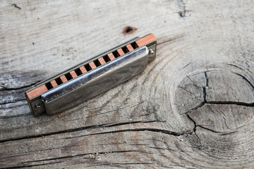 Blues harmonica on a wooden background