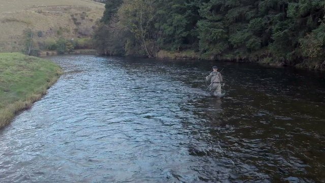 Aerial shot of a man fly fishing in the River Tweed in the Scottish Borders