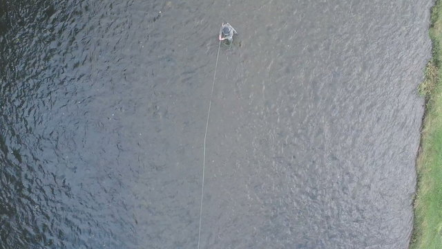 Aerial shot of a man fly fishing in the River Tweed in the Scottish Borders