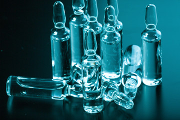  medical ampoules on a dark background