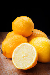 Fresh lemons on a scratched wooden table