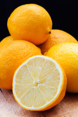 Fresh lemons on a scratched wooden table