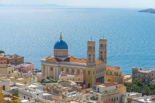 Imposive church among traditional neoclassical houses by the sea