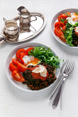 breakfast buffet with a salad of tomato and arugula, black beans