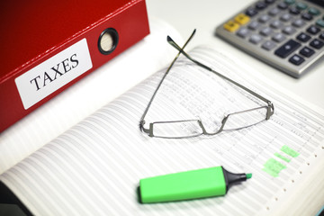 Tax calculator pen and glasses