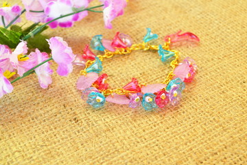 Bright bracelet on burlap