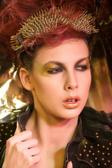 \young girl with red hair wearing glasses with gold spikes in th