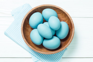 Easter concept with colored eggs on wooden background
