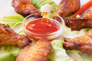 Grilled chicken wings with spicy ketchup.