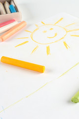 Child's drawing of a smiling sun.
