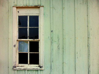 Off-center old window on wooden farmhouse wall - landscape photo