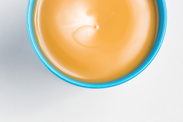 Close up of cup with coffee on white background, top view