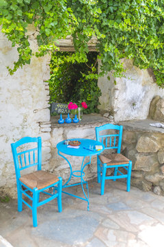Traditional greek tavern in the narrow streets of Mykonos, Greec