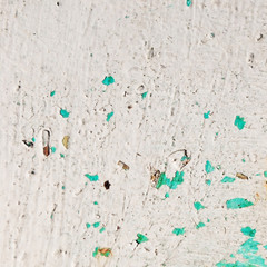 Rusty white metal surface with turquoise cracked paint