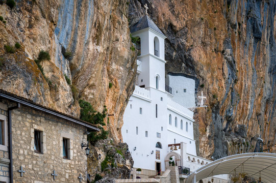Ostrog monastery upper church. White tower in the cave of a mountain. Montenegro sightseeing.