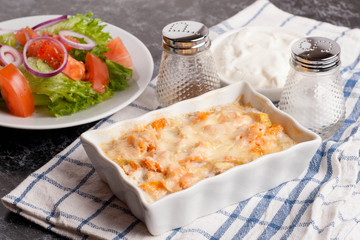 fish gratin with cream, cheese and pumpkin. French dish julienne