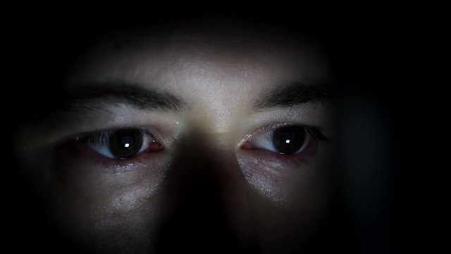 Man hidden in the dark with light in the eyes. Scared Man's Eyes hidden in the dark - 1080p