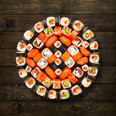 Set of sushi, maki and rolls isolated at wood