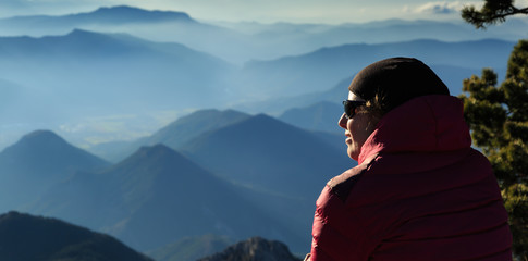 Female hiker enjoying the view from the Vercors plateau, France.