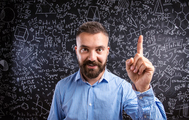 Scolding teacher against big blackboard with mathematical symbol