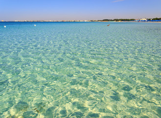 The most beautiful sandy beaches of Apulia:Porto Cesareo marine,Salento coast.ITALY (Lecce).Man alone swimming in crystal clear water.