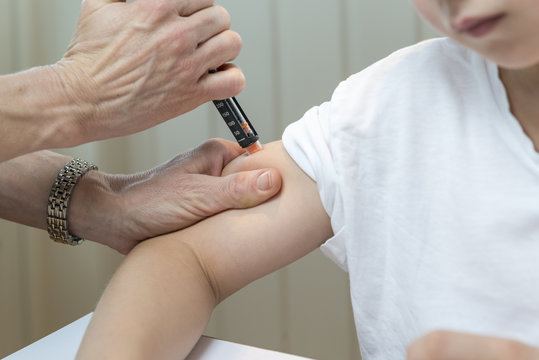 Boy getting insulin after measuring glucose or blood suger level