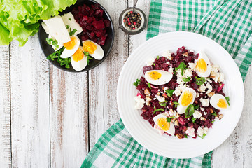 Salad baked beets, feta cheese, eggs, and walnuts. Top view