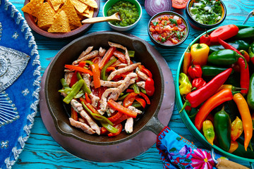 chicken fajitas in a pan chili and sides Mexican