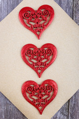 Valentines Day composition - red hearts on gold glistening background