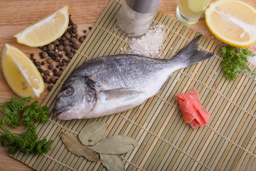  fresh fish with lemon, butter, salt and pepper