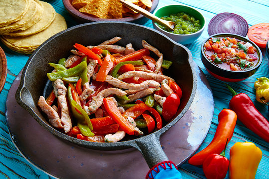 chicken fajitas in a pan chili and sides Mexican