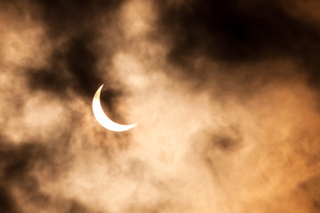 Fototapeta na wymiar Partial solar eclipse through clouds