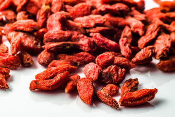 Macro detail of goji berries on a white background. Healthy food and lifestyle