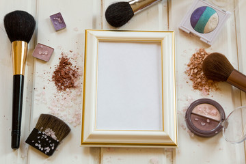 women's accessories cosmetics. Makeup brushes and crushed eyeshadow on wooden background, vintage...