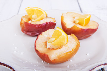 Baked apples on a plate with lemon and citrus puree of apples and pumpkins