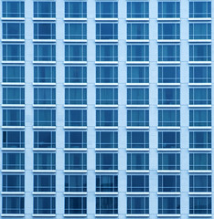 Close-up texture view of blue skyscraper with many windows in Bangkok.