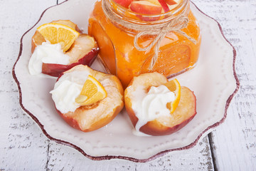 Baked apples on a plate with lemon and citrus puree of apples and pumpkins