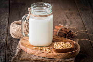 cedar milk in a glass jar and pine nuts