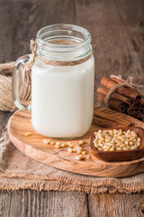 cedar milk in a glass jar and pine nuts