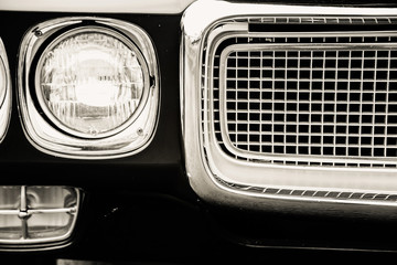 Fototapeta na wymiar Photograph of a classic vehicle with close-up on headlights.